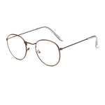 Glasses made out of thin alloy material in a bright brown finish. The material is smooth and the lens are transparent.