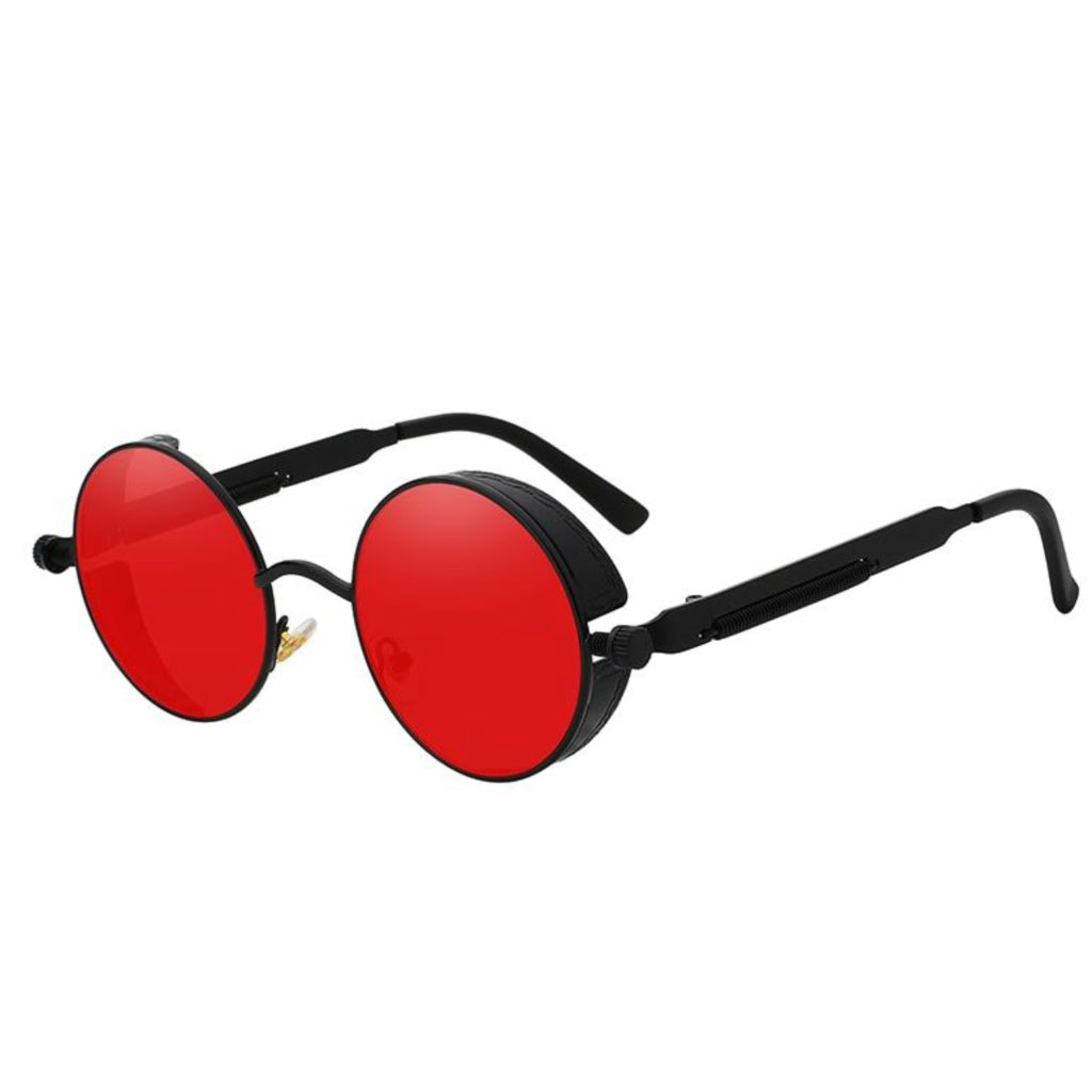 Stylish sunglasses with a red lens and a black rounded frame. The edges of the frames are extended by a small stylish bezel to cover the top and bottom of the eyes. With a spring attached across to the lower part of the handles.