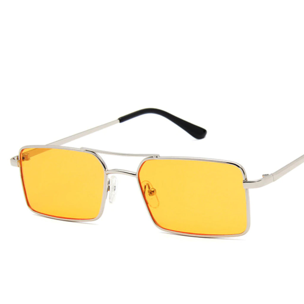 Sunglasses with a thin build and rectangle-shaped lens. The frame is silver and has a simple line connecting two parts at the top and in the middle of the lens. The colour of the lens is a light tint orange.