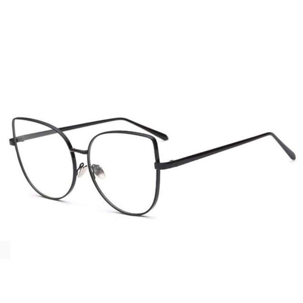 Risque-BlackFrameGlasses  A pair of cat-eye styled glasses with a pointy corner at the top right and left with a circular design frame. A smooth round edge with a strong, sturdy black finish around the lens. The lens is transparent.