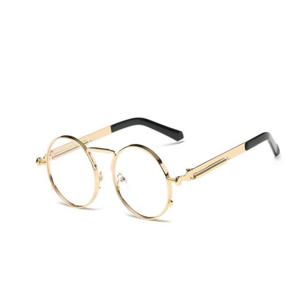 A round pair of glasses with a gold ring-shaped frame around the lens. With a thin design around the handles and a thin line between the top lens. The lens is transparent.